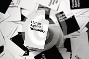 Cards Against Humanity overhead view with scattered cards in background