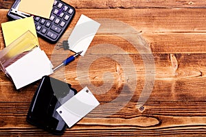 Cards in card holder near pen on wooden background