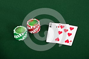 Cards And Chips For Poker On Green Table