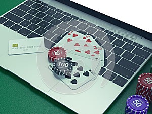 Cards and chips for poker on notebook.