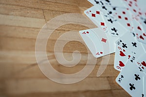 Cards lying on rustic wood table, playing cards. Copy space