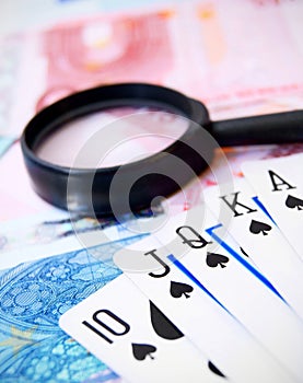 Cards and a magnifier on money (euro).