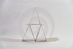 cards placed in the form of a pyramid on a white table