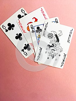 Cards for playing poker are at the top of the pink background. Place for text