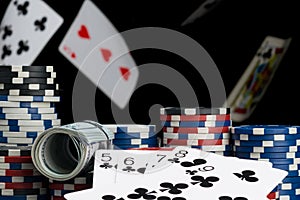 Cards and poker chips on the background of falling cards