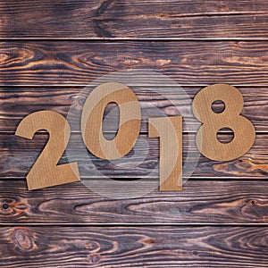 Cardstock Numbers 2018 Happy New Year Sign over table. 3d Render