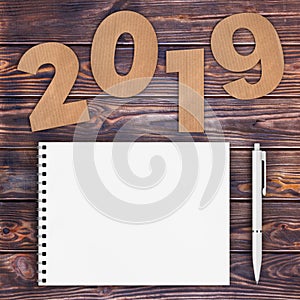 Cardstock Numbers 2019 Happy New Year Sign near White Spiral Pap