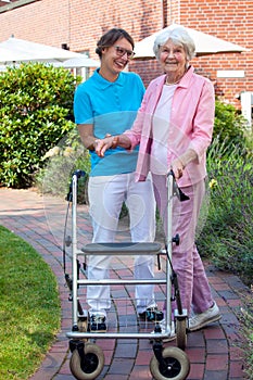 Care assistant helping an elderly lady