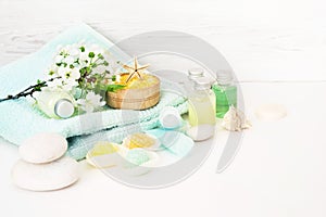 Aromatic salt for Spa therapies, cosmetics for a body and acceptance of bathtubs, towel and a spring flower photo