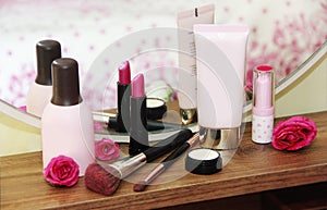 Care and decorative cosmetics, face lotion, body cream, lip gloss, lipstick, makeup a brushes photo