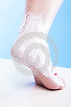 Care for dry skin on the well-groomed feet and heels with creams