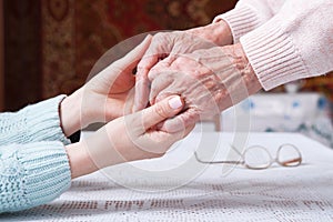 Care is at home of elderly. Senior woman with their caregiver at home. Concept of health care for elderly old people photo
