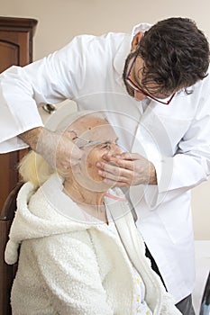 Care and nursing of an old woman. Eyebrow trimming and adjustment. Care treatments.