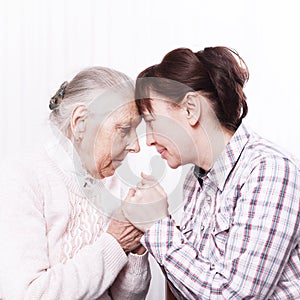 Care of senior woman at home sitting on the couch