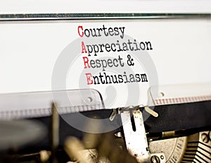 CARE symbol. Concept words CARE courtesy appreciation respect and enthusiasm on typewriter on beautiful white background. Business