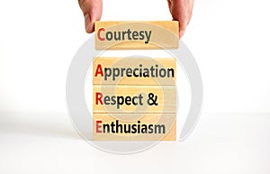 CARE symbol. Concept words CARE courtesy appreciation respect and enthusiasm on wooden block on white background.