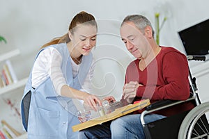 Care worker giving older man dinner