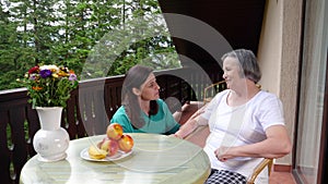 Care worker spending time with old lady in her home