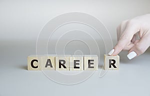 Career adviser assembling the word career with six wooden cubes in a conceptual image of personal guidance towards self