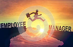 Career jump. Silhouette of man jumping from employee cliff to manager cliff against backdrop of sunset sky. Motivation for career