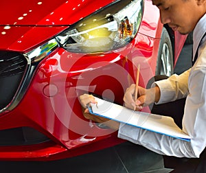 career man saleman business inspection writing on notepad or book, paper with car blurry background.for transport automobile autom photo