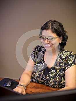 Career-Minded Female Professional Using Laptop