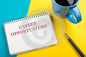 Career opportunities. Office desk table with notepad, pencil and coffee cup. Top view.