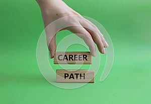 Career path symbol. Concept word Career path on wooden blocks. Beautiful green background. Businessman hand. Business and Career