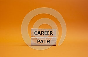 Career path symbol. Concept word Career path on wooden blocks. Beautiful orange background. Business and Career path concept. Copy