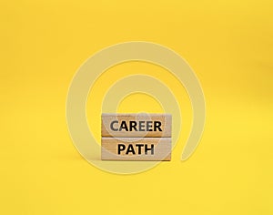 Career path symbol. Concept word Career path on wooden blocks. Beautiful yellow background. Business and Career path concept. Copy