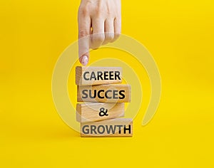 Career success and growth symbol. Wooden blocks with words Career success and growth. Beautiful yellow background. Businessman