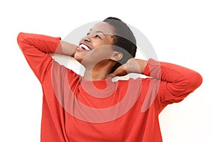 Carefree african american woman against white background with hands behind head