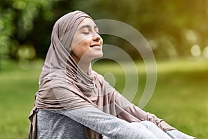 Carefree arab girl taking sunbath at park