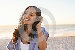 Carefree beautiful latin woman relaxing on beach