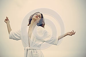 Carefree beauty at home. Woman with closed eyes relax in bathrobe. Young woman with makeup and fresh skin, skincare