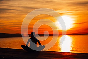 Carefree calm woman meditating in nature.Finding inner peace.Yoga practice.Spiritual healing lifestyle.Enjoying peace,anti-stress photo