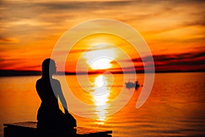 Carefree calm woman meditating in nature.Finding inner peace.Yoga practice.Spiritual healing lifestyle.Enjoying peace,anti-stress photo