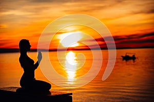 Carefree calm woman meditating in nature.Finding inner peace.Yoga practice.Spiritual healing lifestyle.Enjoying peace,anti-stress photo