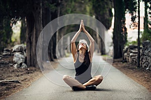 Carefree calm woman meditating in nature.Finding inner peace.Yoga practice.Spiritual healing lifestyle.Enjoying peace,anti-stress photo