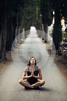 Carefree calm woman meditating in nature.Finding inner peace.Yoga practice.Spiritual healing lifestyle.Enjoying peace,anti-stress