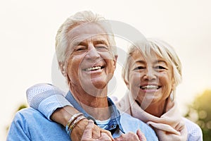 Carefree and cheerful. Portrait of a senior couple enjoying the day together in a park.