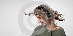 Carefree cheerful young curly woman listen favourite music