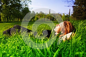 Carefree concept - woman relaxing outdoor in grass