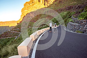 Carefree couple running on the mountain roadside