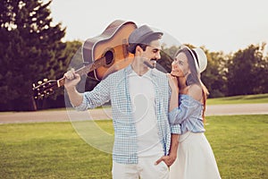 Carefree cute romantic bearded brunet guy in shirt, bonding dreamy lady. Leisure, friends, play music, friendship, chill