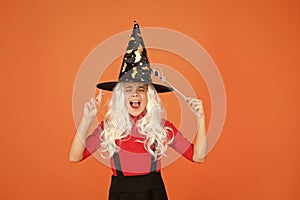 Carefree fun. small girl halloween party. mystery witch do magic. small child witch hat. trick or treat. supernatural