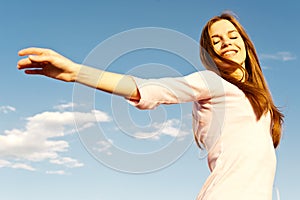 Carefree girl and blue sky