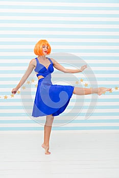 Carefree girl with crazy look makes step. so much fun. crazy girl with orange hair dancing barefoot. totally carefree