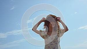 Carefree girl dancing beach in flowery dress close up. Woman have fun on nature.