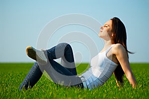 Carefree girl sitting at the field